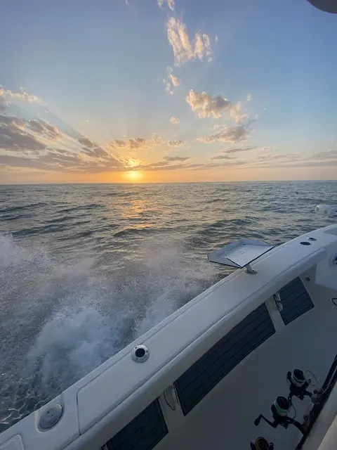 Sunset glowing behind the wake of the Pathfinder