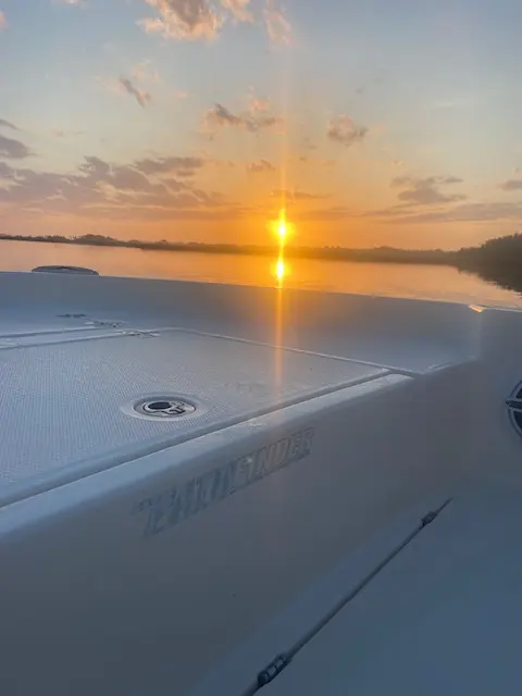 Golden sunset reflected across calm coastal water