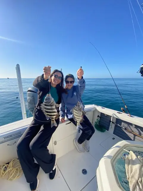 Three guests celebrating a fishing day on the water