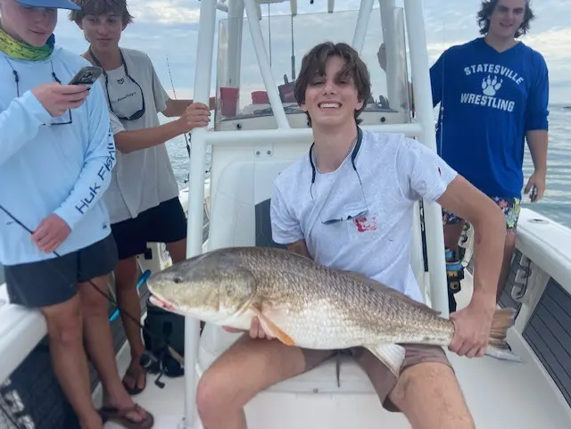 Young anglers displaying their catch aboard the Pathfinder